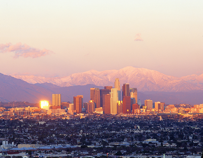 Los Angeles skyline with snow-capped mountains in the background