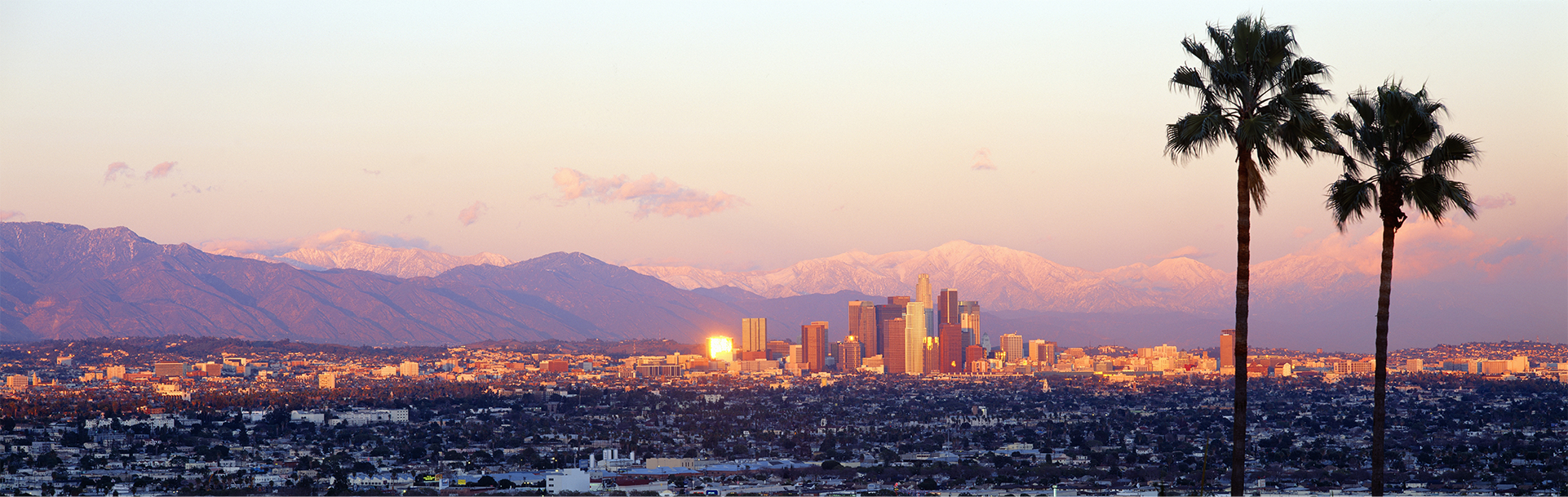 Los Angeles skyline with snow-capped mountains in the background