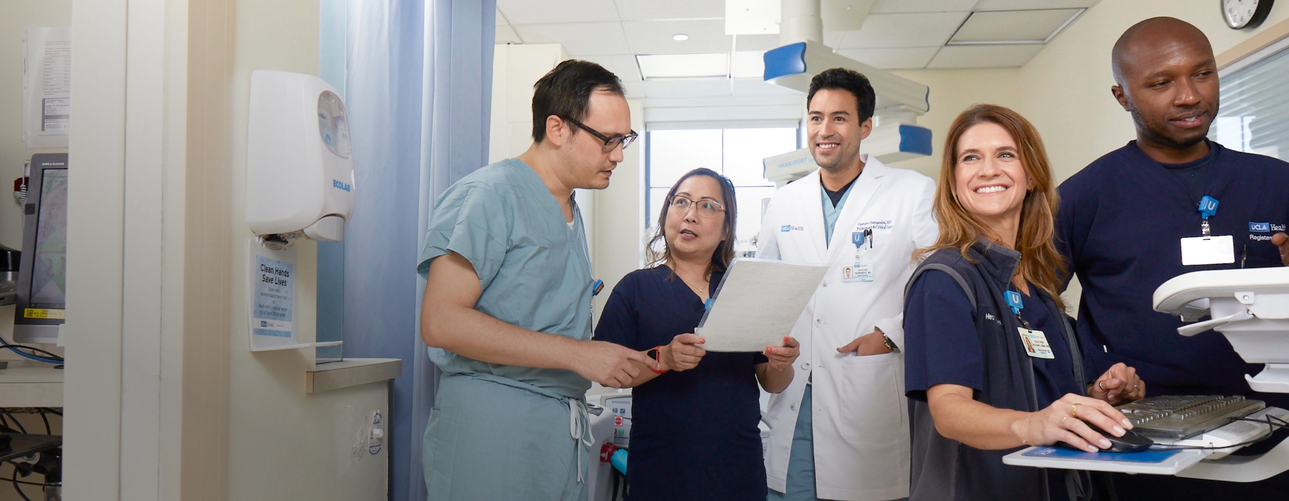 A diverse group of UCLA Health clinical professionals collaborating in a UCLA Health hospital