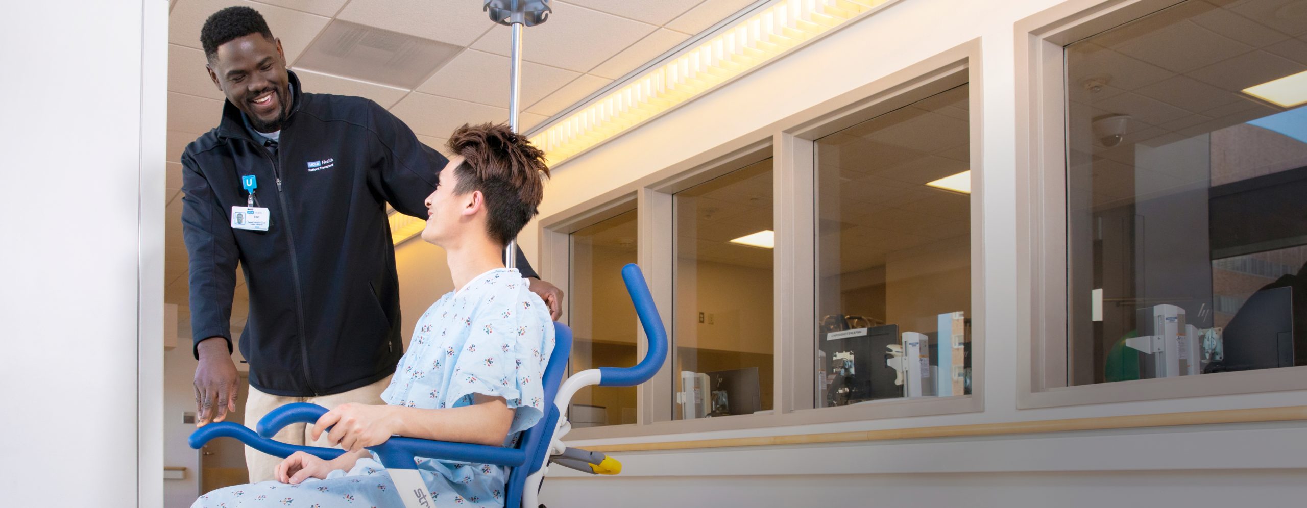 A smiling male African American UCLA Health physical therapist working with a male patient