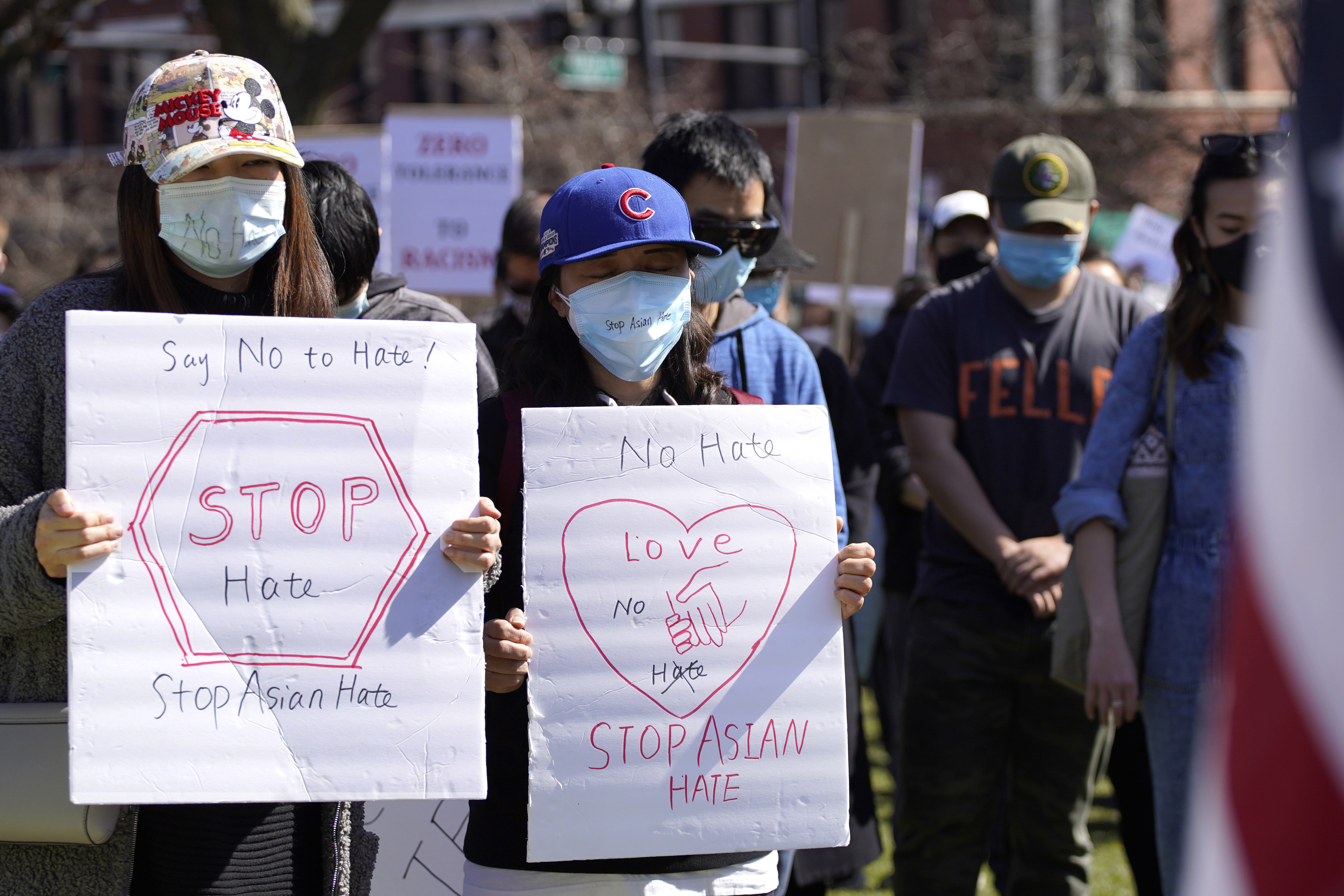 People hold a moment of silence to support Stop Asian Hate at the Logan Square Monument in Chicago, Saturday, March 20, 2021.