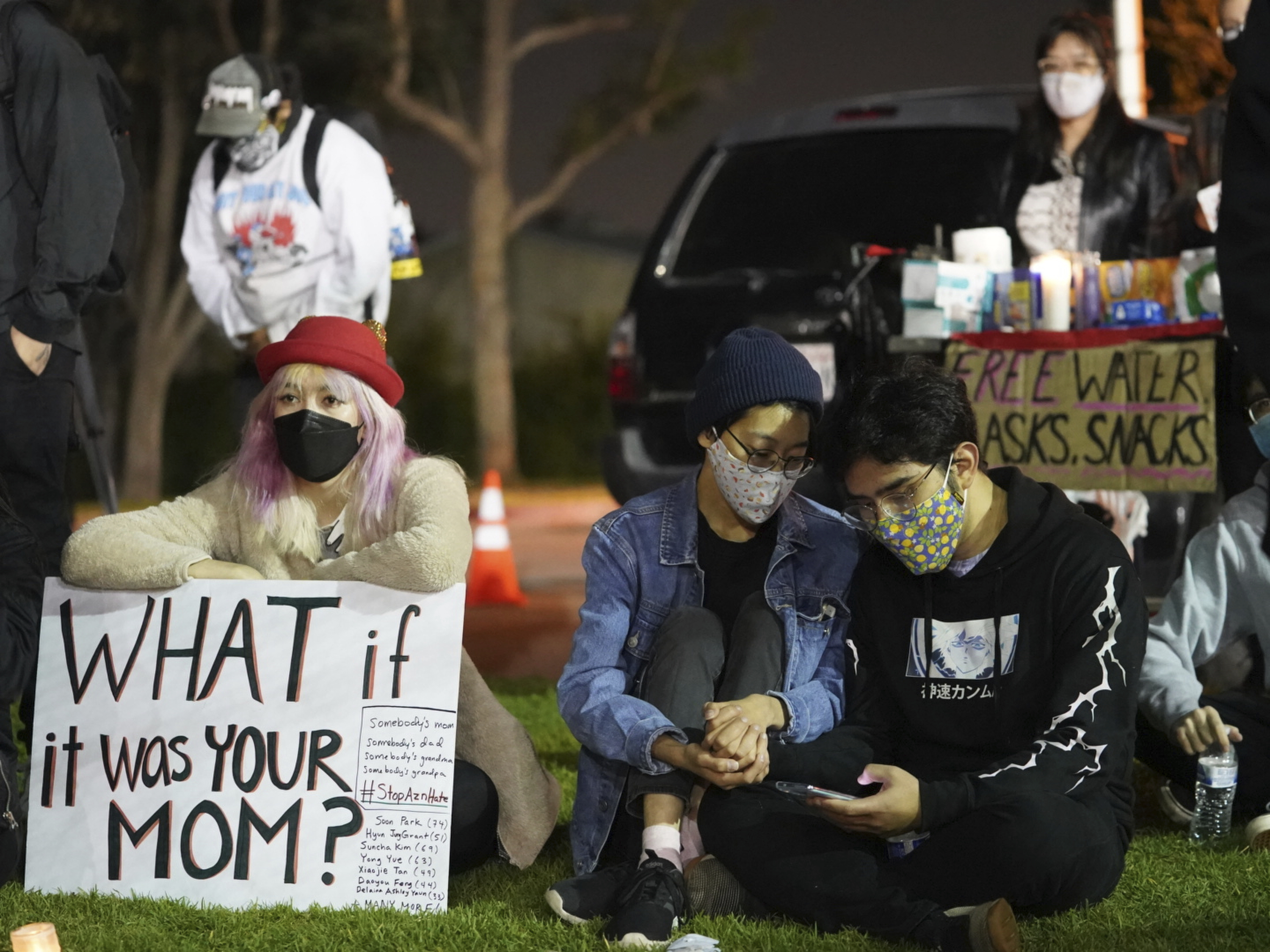 Fashion model Kayla Karns, left with hat, joins hundreds of people gather at a rally "Stop Asian Hate" candlelight vigil at Almansor Park in Alhambra, Calif., March 20, 2021.