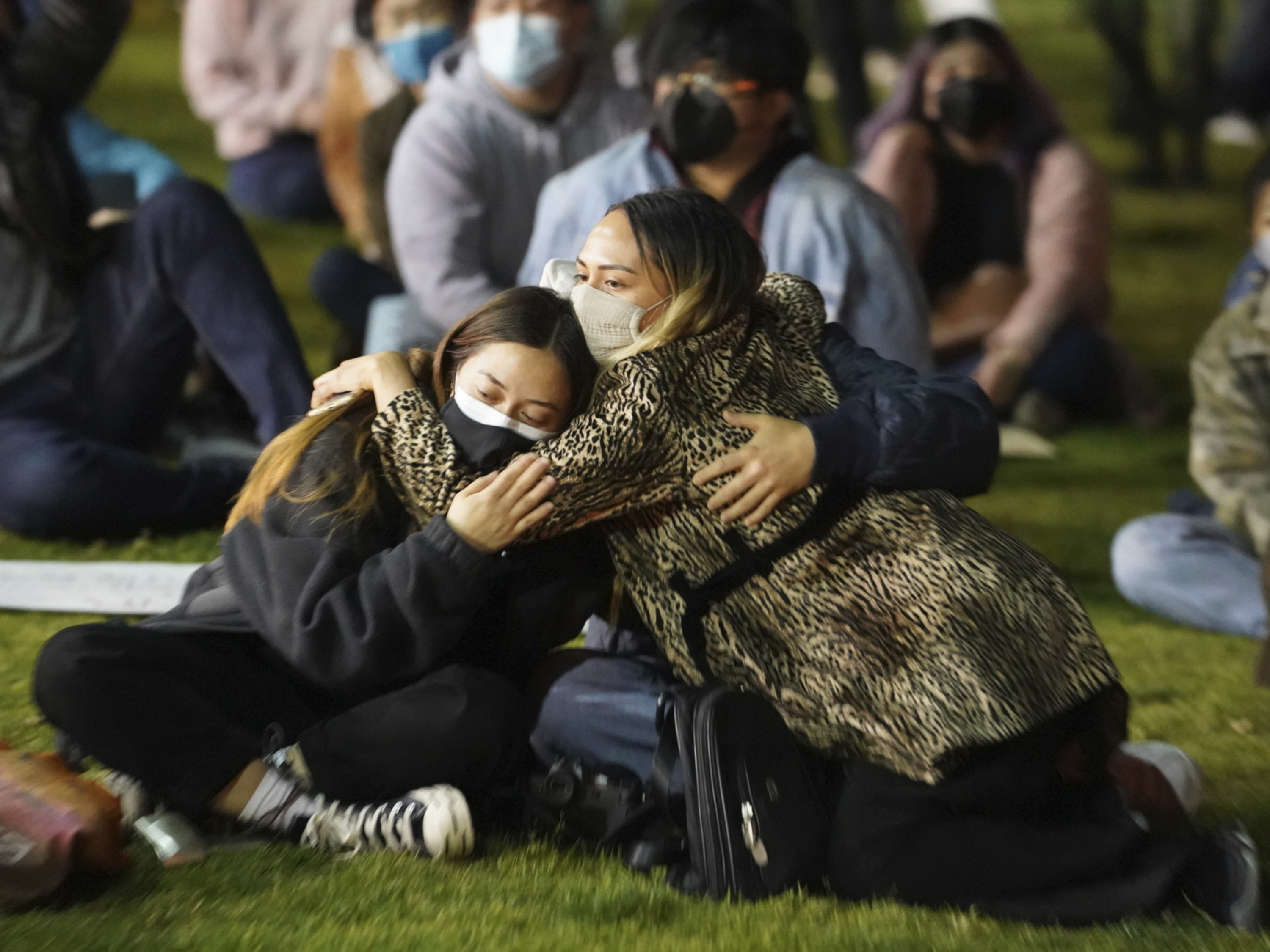 Alanav Hillman, left, and Ashley Alexander hug as they join people gathered at a rally "Stop Asian Hate" candlelight vigil at Almansor Park in Alhambra, Calif., March 20, 2021.