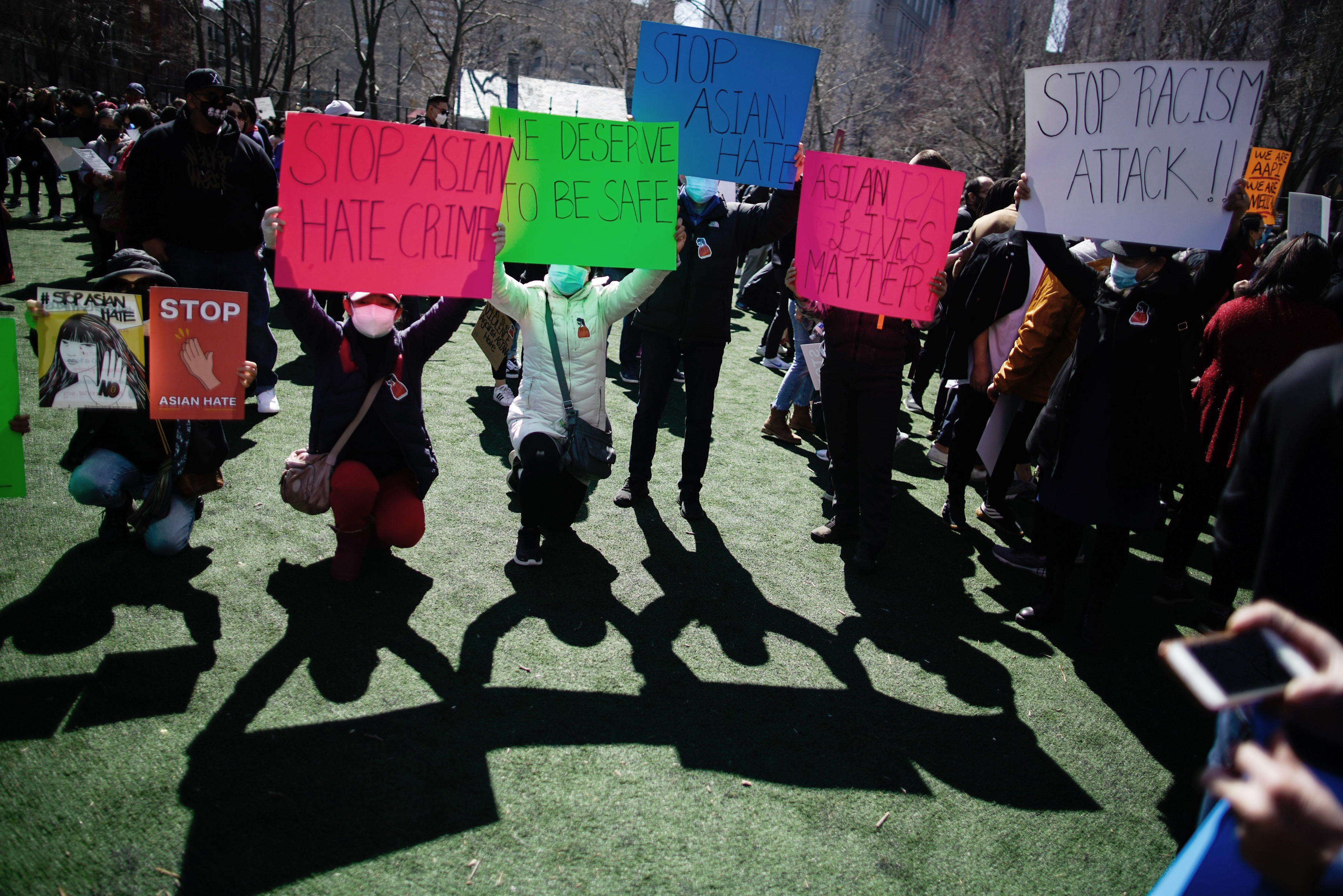 People take part in a rally against hate and confront the rising violence against Asian Americans at Columbus Park in New York, on Sunday, March 21, 2021.