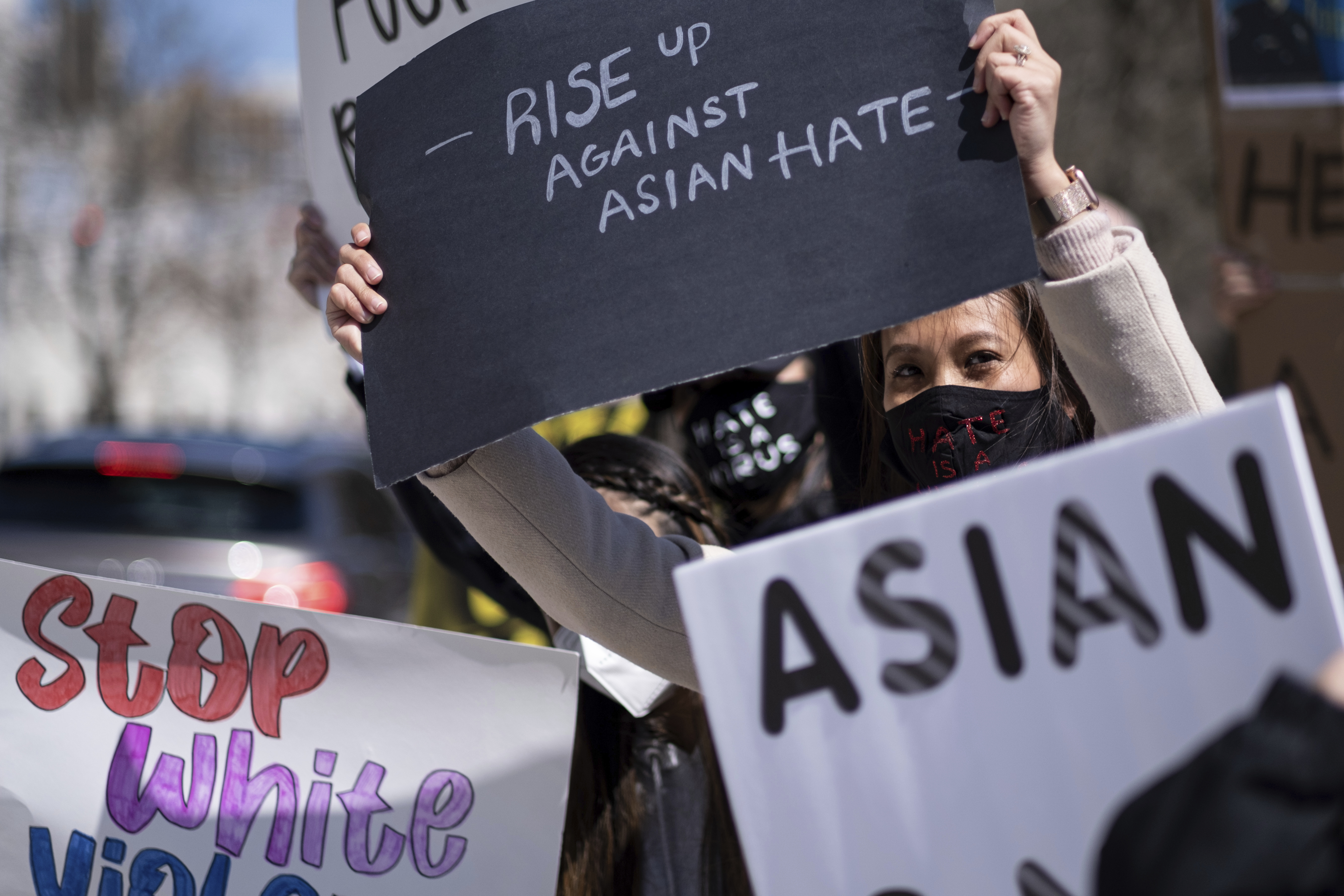 Mai Wright holds a sign while participating in a "stop Asian hate" rally outside the Georgia State Capitol in Atlanta on Saturday afternoon, March 20, 2021.