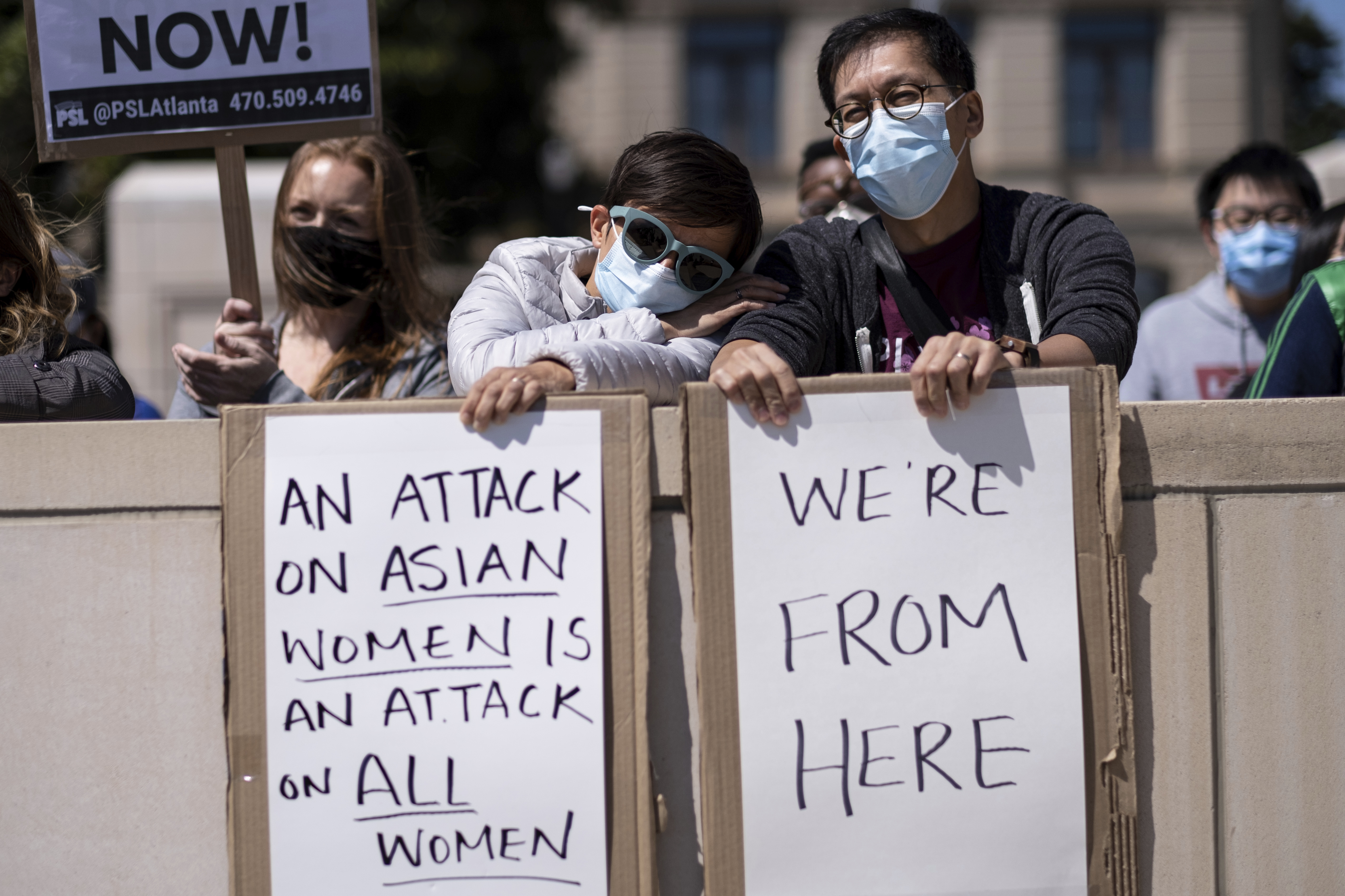 Agata Rozga leans her head on Rich Vuduc's arm as they participate in a "stop Asian hate" rally outside the Georgia State Capitol in Atlanta on Saturday afternoon, March 20, 2021.