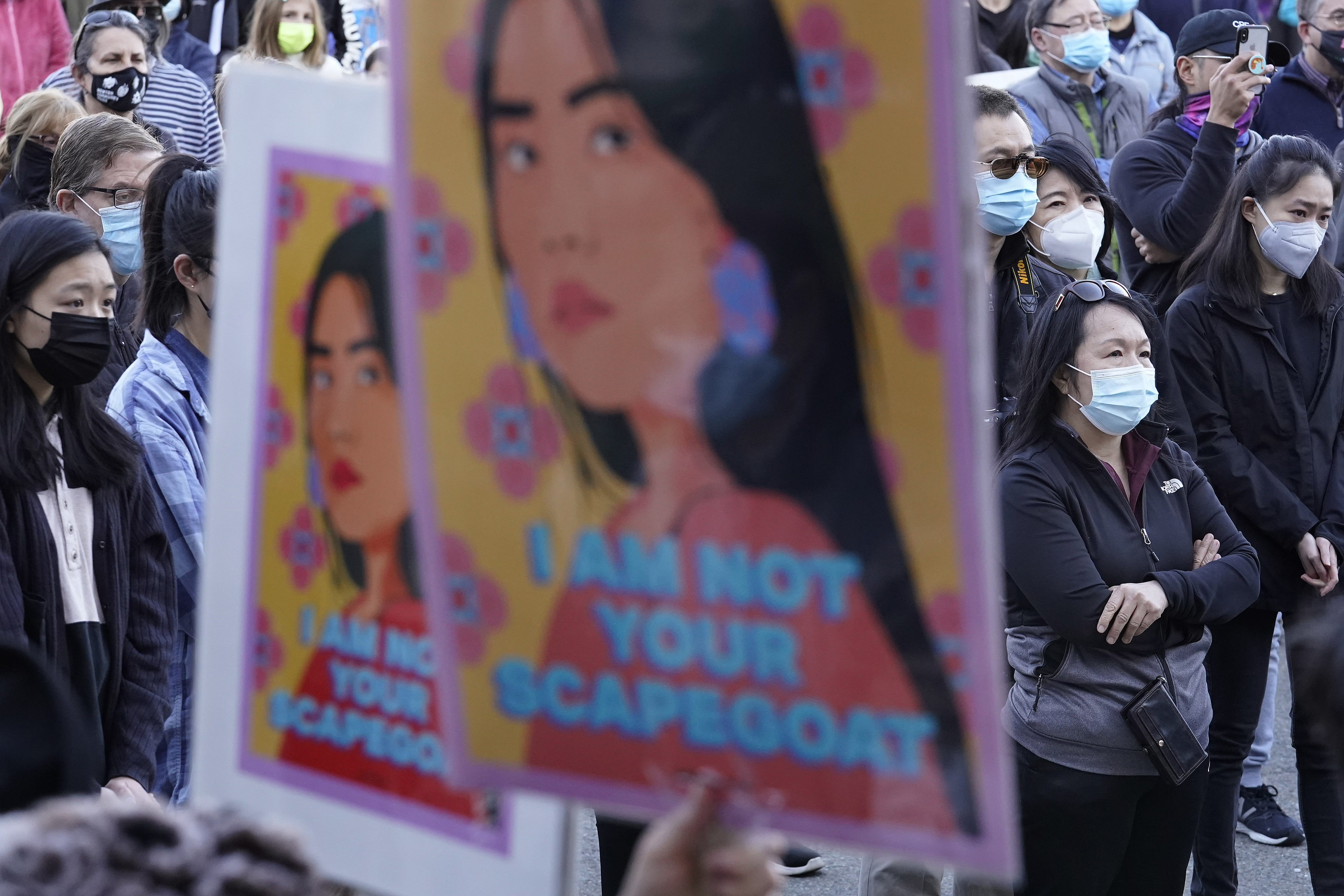 Protesters display placards during a rally held to support Stop Asian Hate, Sunday, March 21, 2021, in Newton, Mass.