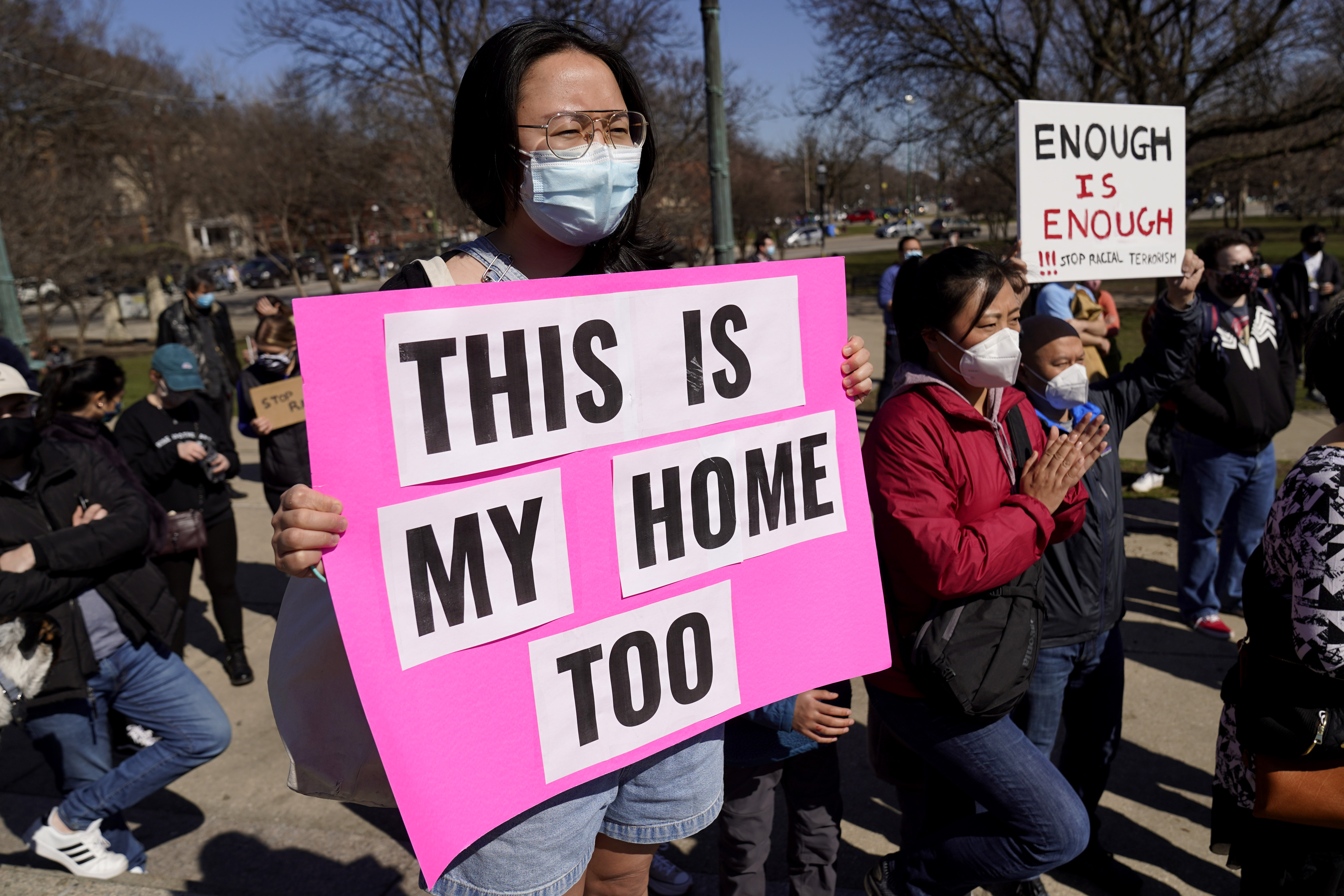 Mary Yoo holds a sign as she attends a rally to support Stop Asian Hate at the Logan Square Monument in Chicago, Saturday, March 20, 2021.