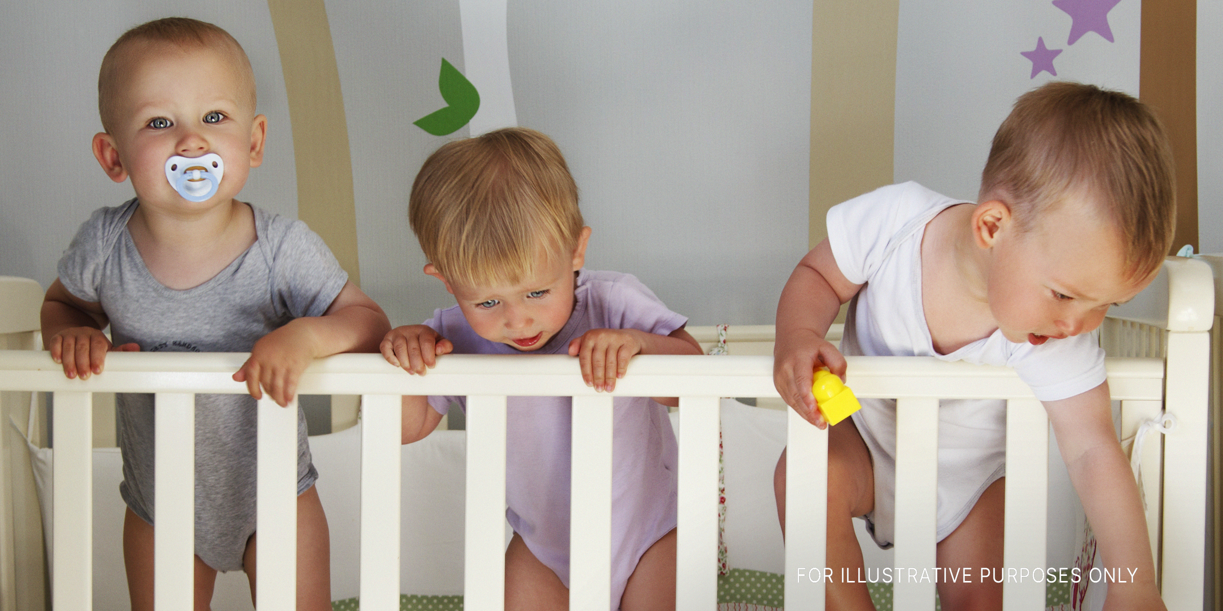 Three babies in a crib | Source: Shutterstock