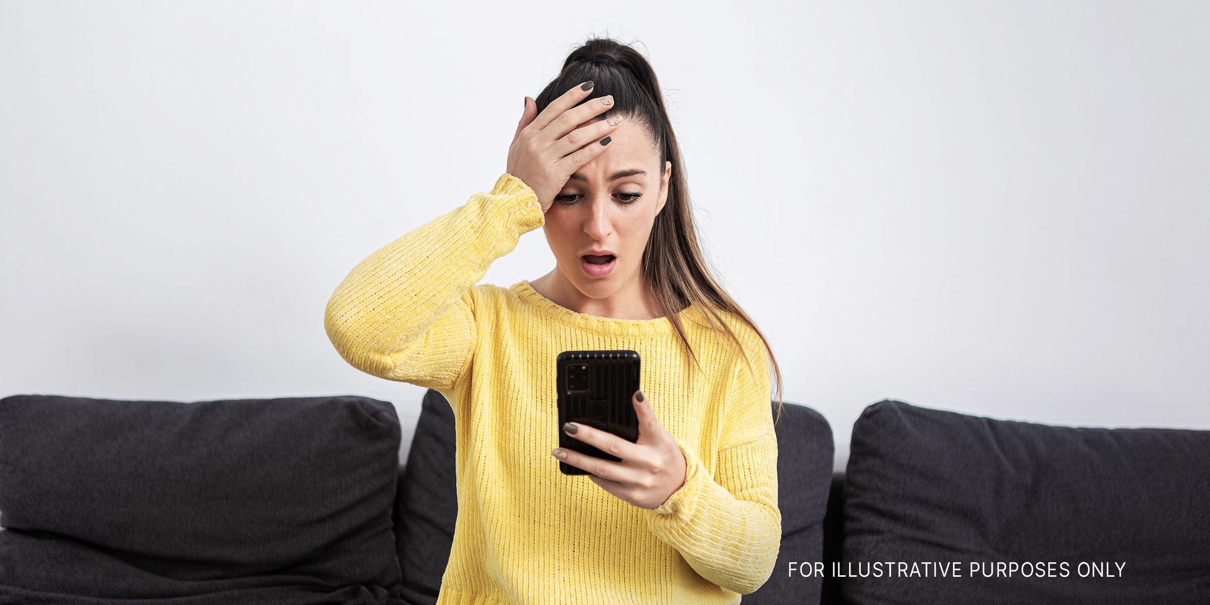 A woman is shocked while looking at her mobile phone screen | Source: Getty Images