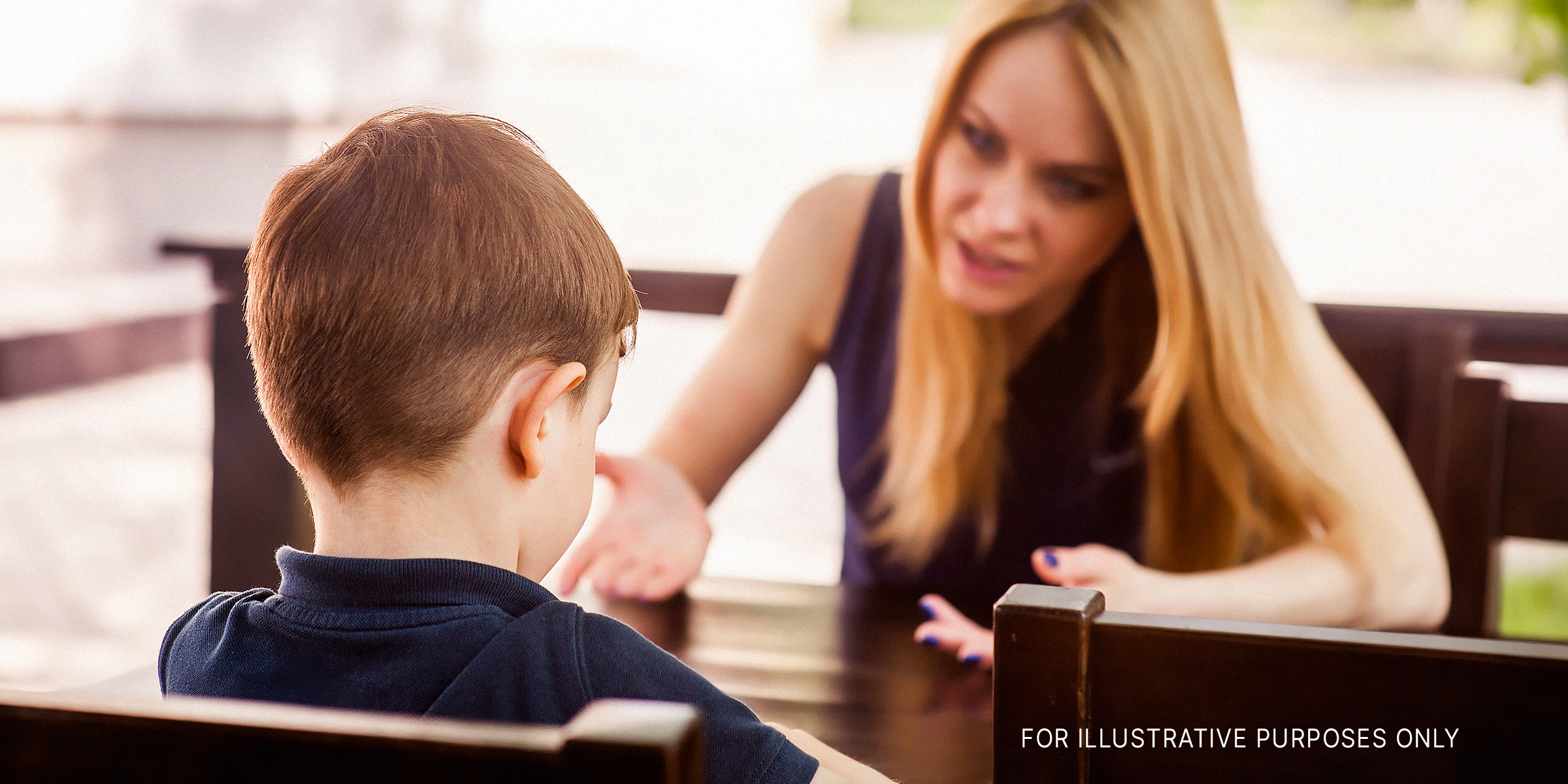 Woman talking to a young boy | Source: Shutterstock