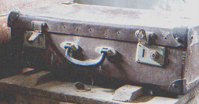 An old suitcase covered in dust | Source: Shutterstock