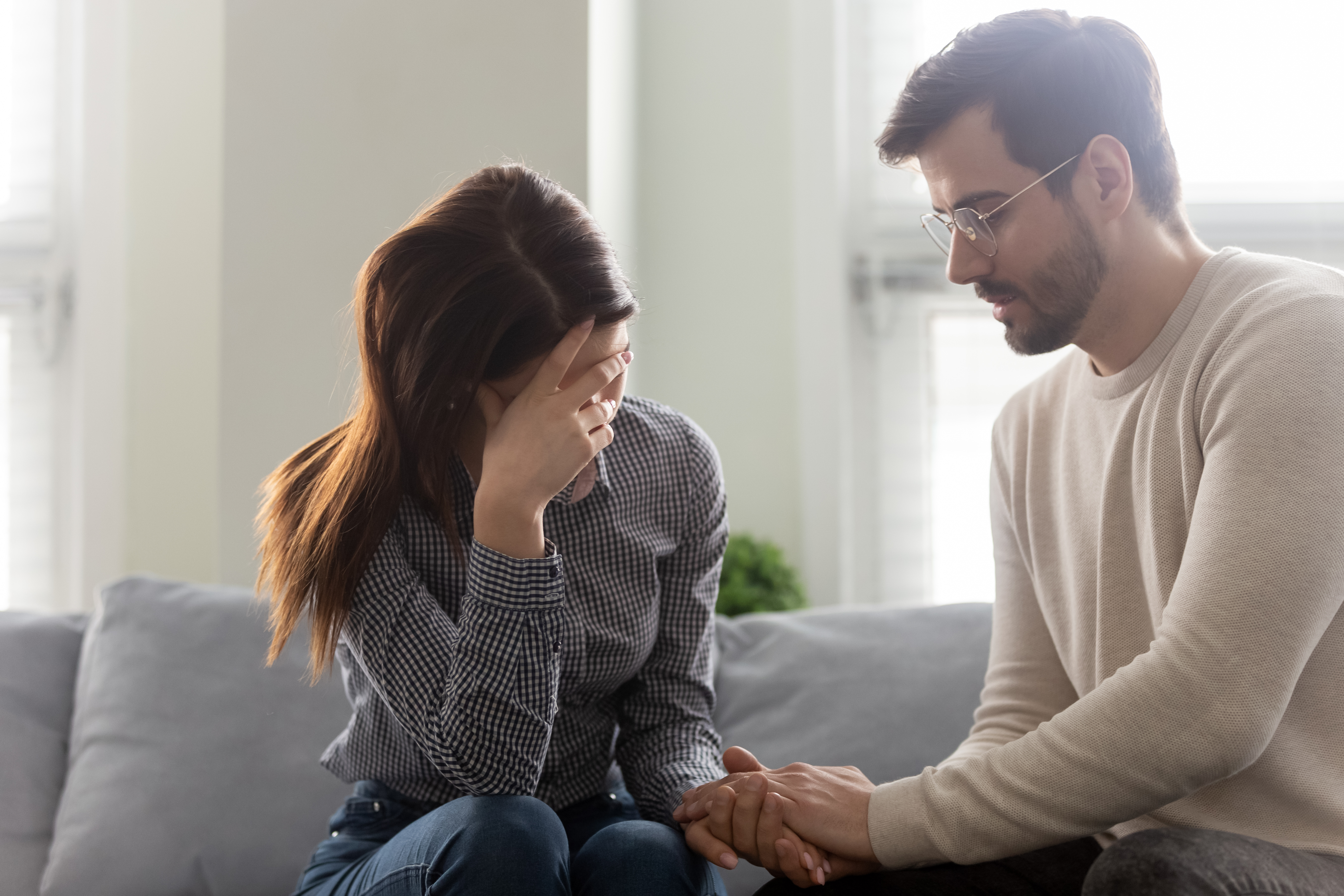 A husband comforting his distressed wife | Source: Shutterstock