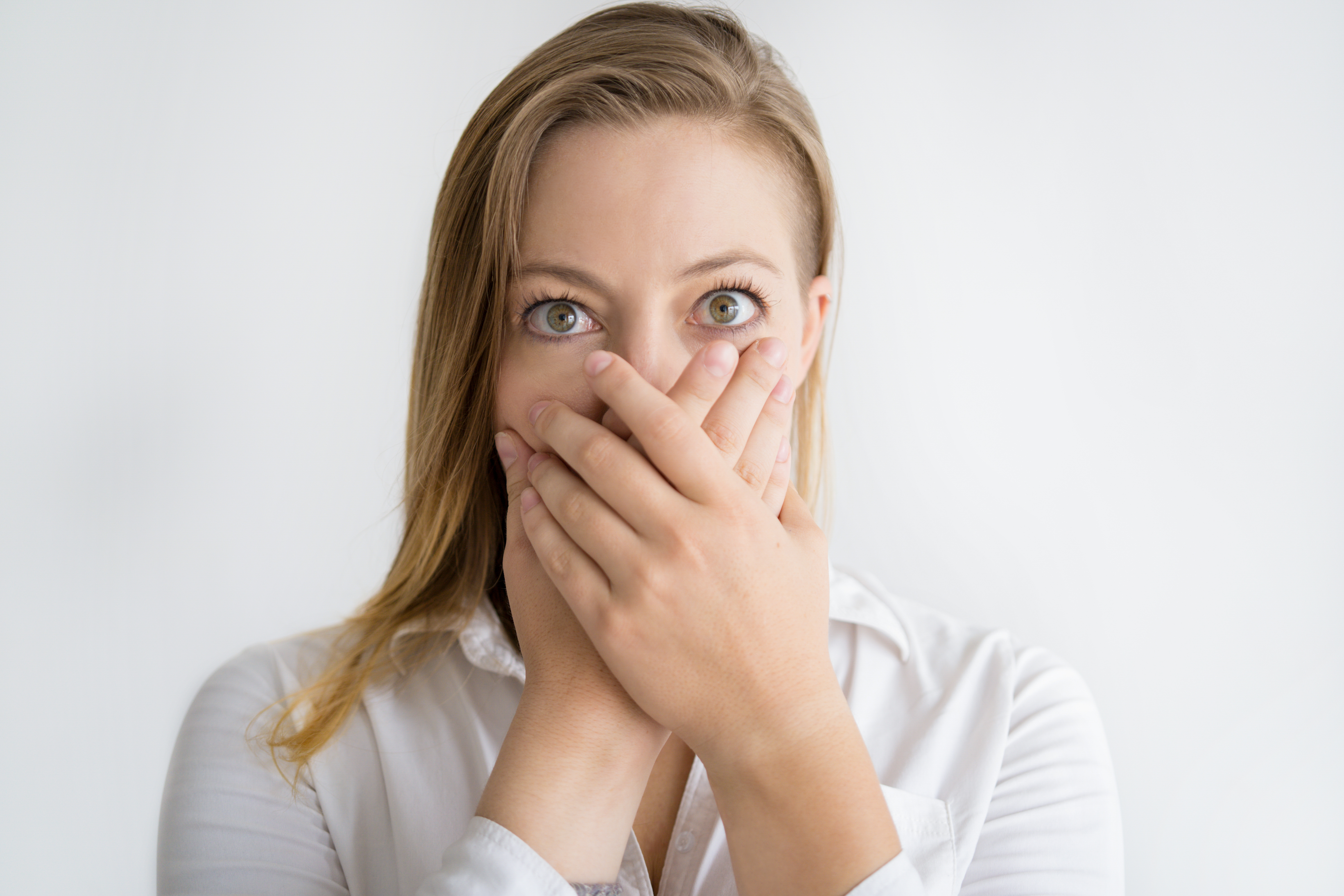 A shocked woman covering her face with her hands | Source: Getty Images