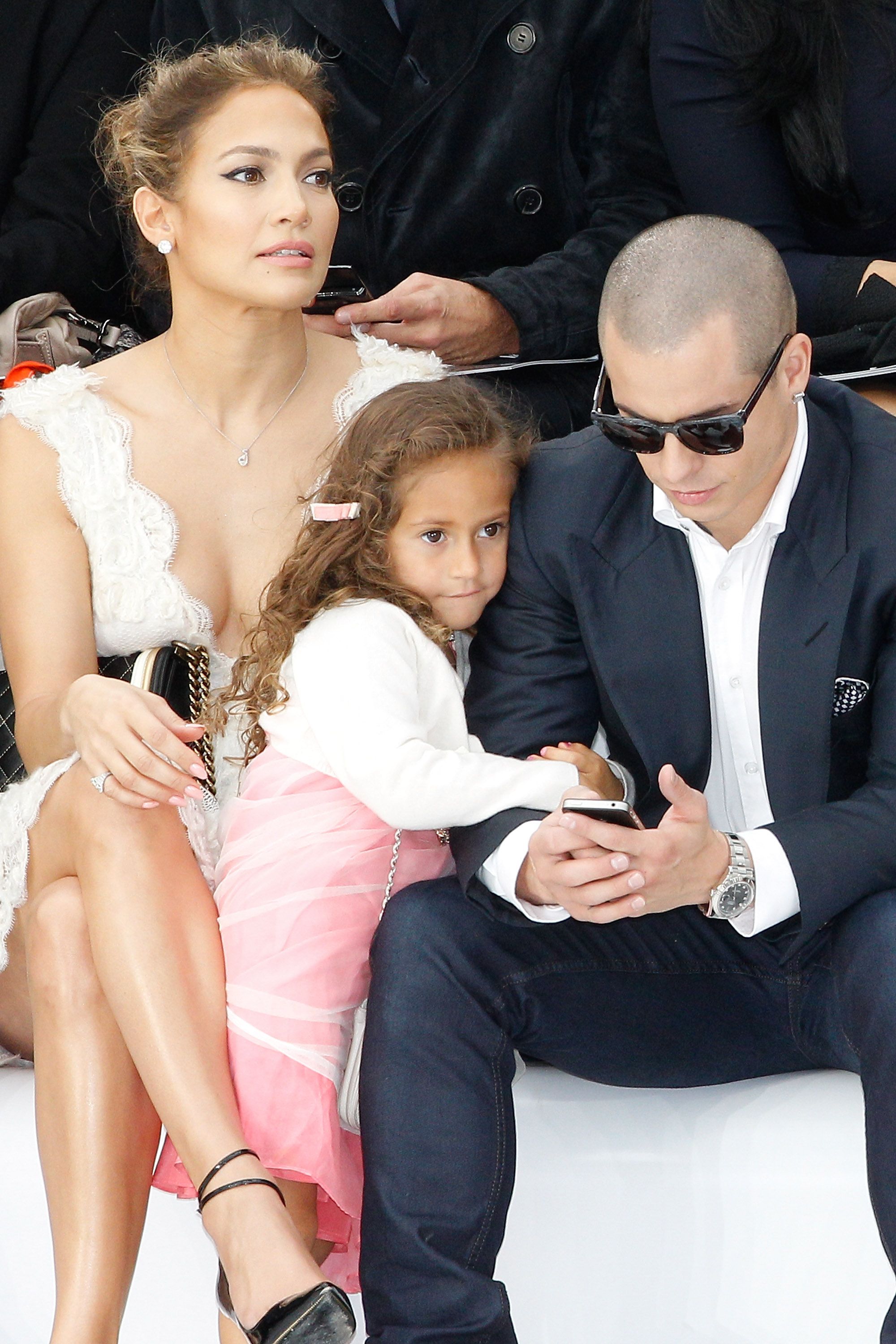 Jennifer Lopez, Emme Maribel Muniz, and Casper Smart during the Chanel Spring / Summer 2013 show at Grand Palais on October 2, 2012, in Paris, France. | Source: Getty Images