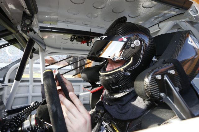 A NASCAR driver sitting in his car