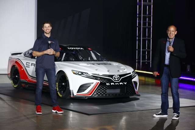 NASCAR driver Denny Hamlin and Toyota Racing Development USA President and General Manager David Wilson speak at the unveiling of the seventh generation of the NASCAR Cup Series Toyota car during the NASCAR Next Gen Car Announcement on May 05, 2021 in Charlotte, North Carolina.