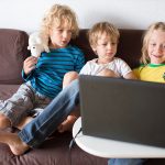 Kids looking at a laptop