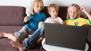 Kids looking at a laptop