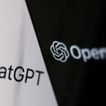 OpenAI logo displayed on a phone screen and ChatGPT website displayed on a laptop screen.