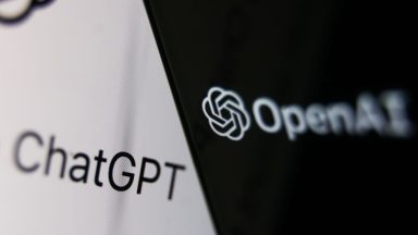 OpenAI logo displayed on a phone screen and ChatGPT website displayed on a laptop screen.