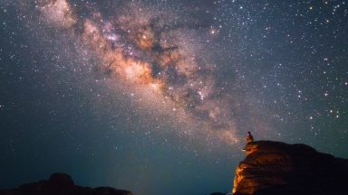 Silhouette of a man looking at the Milky Way Stars shining above the Grand Canyon of Thailand (Sam Phan Bok)