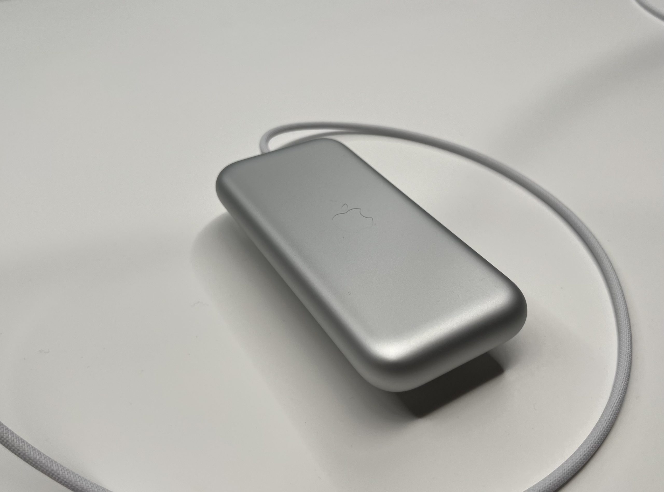 An iPhone-sized battery pack connected to a thick wire