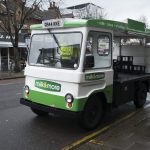 A white and green milk float