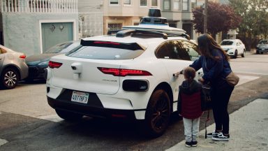 Passengers getting into a Waymo