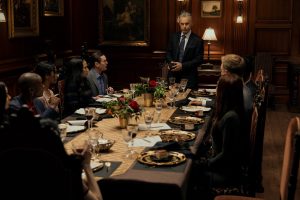 group of people seated at a formal dinner table