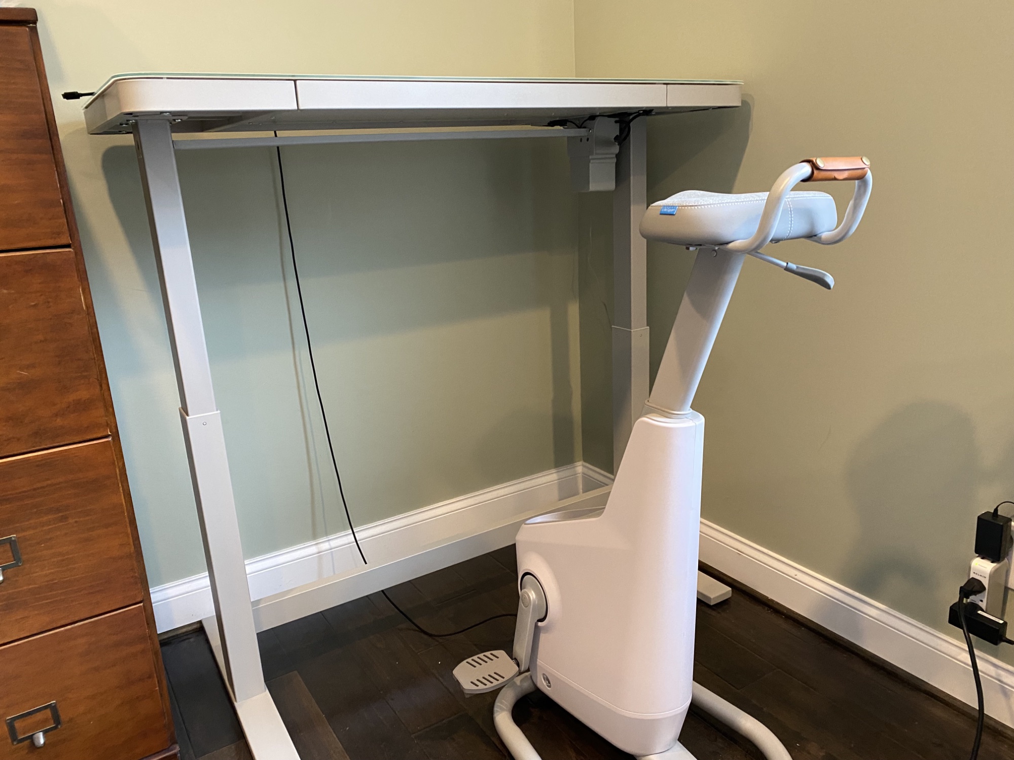 Image of a stationary bicycle and a tall standing desk.