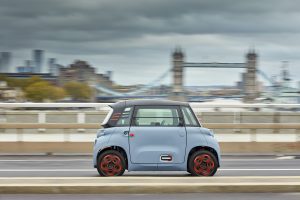 A Citroen Ami driving across a bridge in London