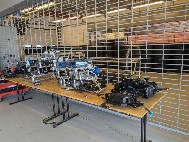 Mechanical and electronic equipment on a table in a garage at a race track