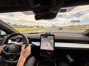 A man drives a polestar 3 down a highway