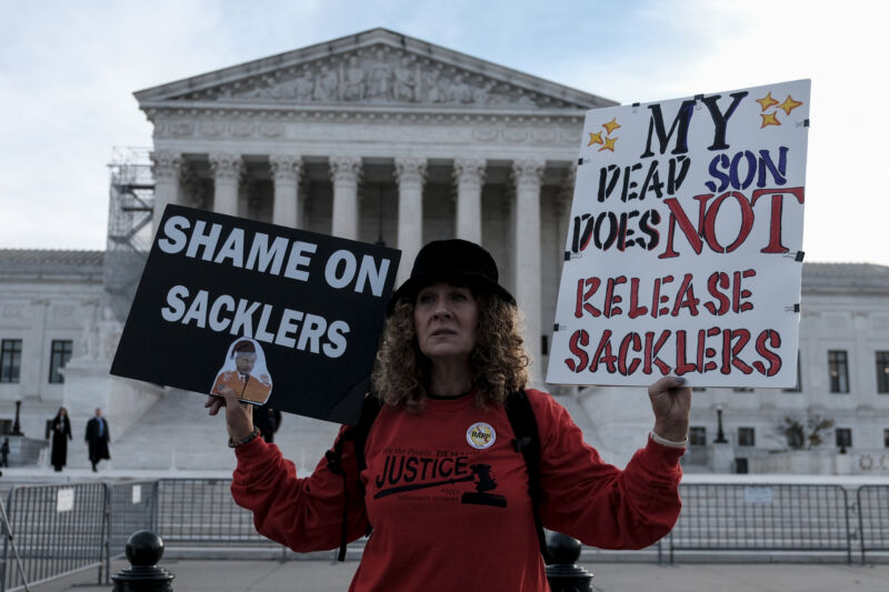 Grace Bisch holds a picture of stepson Eddie Bisch who died as a result of an overdose on outside of the U.S. Supreme Court on December 4, 2023  in Washington, DC. The Supreme Court heard arguments regarding a nationwide settlement with Purdue Pharma, the manufacturer of OxyContin. 