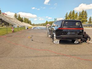 A Rivian engineer prepares a car for a drag run