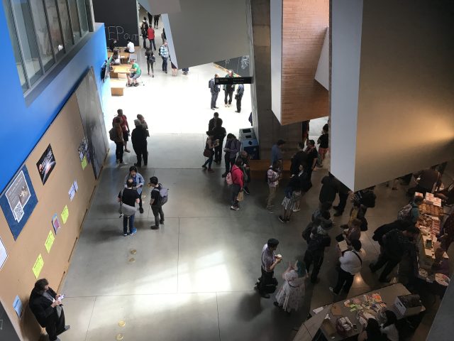 A crown assembles in a convention center