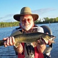 Image of Larry Finger, holding a fish