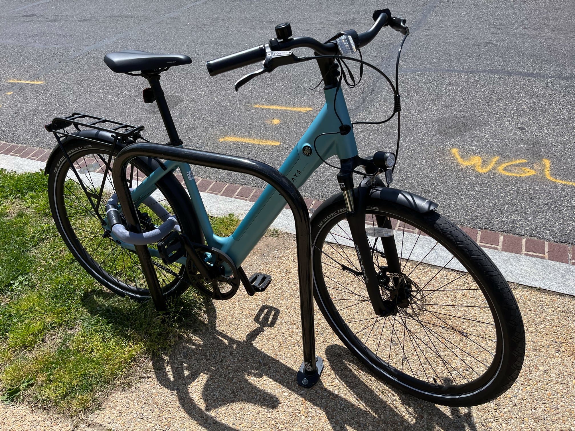 Tenways CGO800S, locked to a rack, on a street.