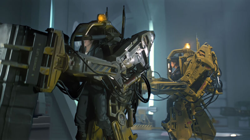 Image of two people using powered exoskeletons to move heavy items around, as seen in the movie Aliens.