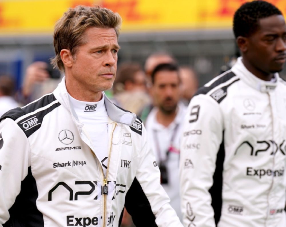 two men in white racing suits striding purposefully