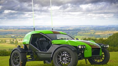 A green and black Ariel E-Nomad seen in the English countryside