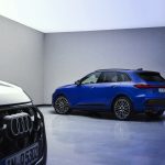 A blue Audi SQ5 and a black Audi Q5 seen in a studio