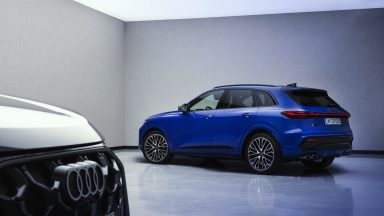 A blue Audi SQ5 and a black Audi Q5 seen in a studio