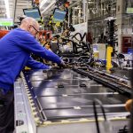 A VW worker assembles an EV battery pack