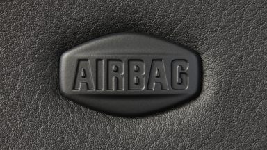 Macro of car airbag sign on leather