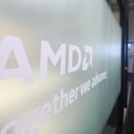 Visitors walk past the AMD booth at the 2024 Mobile World Congress