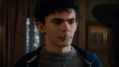 young Goth teen with magical writing over his mouth