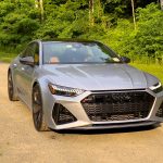 A silver Audi RS7 parked in a clearing