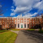 A formal red brick building on a college campus.